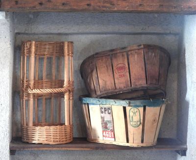 two baskets and a basket on a shelf in a room