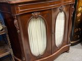a wooden cabinet with a mirror on top of it