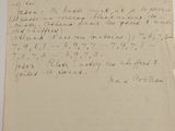 an old piece of paper with writing on it sitting on a table