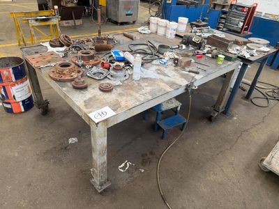 a table with a lot of tools on it in a garage