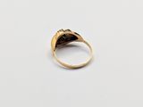 a close up of a gold ring on a white surface