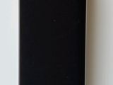 a black speaker sitting on top of a white table