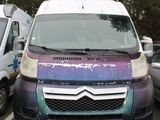 purple and blue van parked in a parking lot next to other cars
