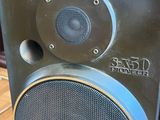 a speaker that is sitting on top of a wooden table
