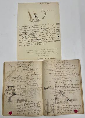 an old book with a drawing on it and a piece of paper with writing on it