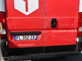 a red delivery truck parked in a parking lot