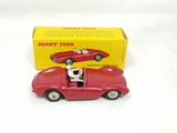 a red toy car with a man sitting in the driver ' s seat