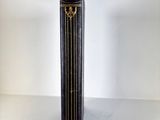 a black and gold book on a white table