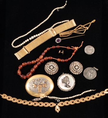 several pieces of jewelry are displayed on a black surface