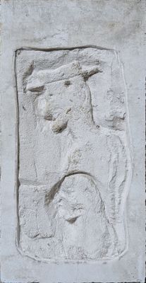 a stone relief of a man and a woman on a wall