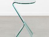 a glass side table with a curved glass top