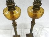 two glass vases sitting on a table next to each other