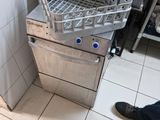 a silver dishwasher sitting on the floor in a kitchen