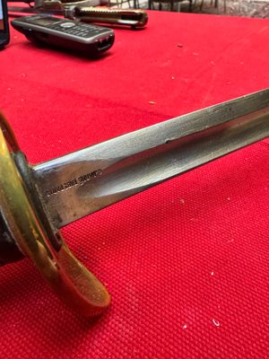 a close up of a knife on a red table