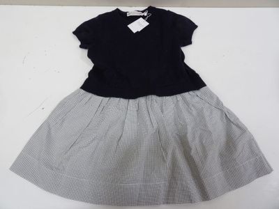 black and white checkered dress with bow tie on a hanger