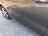 a black car parked on the side of the road