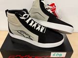 a pair of black and white sneakers on top of a box
