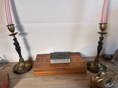 two candles that are sitting on a table with a book