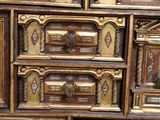 a close up of a wooden cabinet with many drawers