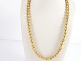 a gold beaded necklace on a mannequin mannequin mannequin mannequin mannequin mannequin mannequin mannequin mann