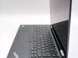 a laptop computer that is open on a white surface