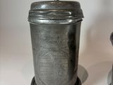 two metal containers sitting next to each other on a table