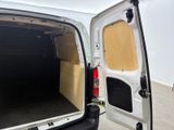 a white van with its doors open in a room
