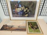 two framed pictures of birds and flowers on a table