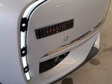 a close up of a white car with a clock on it