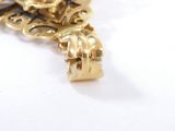 an image of a close up of a gold cross on a white surface