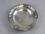 a silver plate on a table with a white table cloth