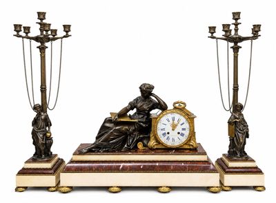 a statue of a woman sitting on a table next to a clock