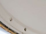 a close up of a white plate with holes in it