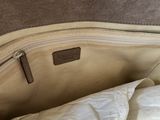 the inside of a white purse with a zipper on it