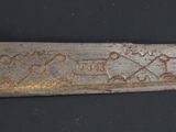 a very old knife that is on a black table