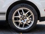 a close up of a tire on a white car