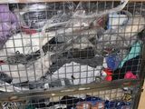 a metal cart with many items in it in a warehouse