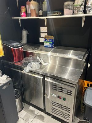 a stainless steel sink in the corner of a kitchen