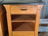 two wooden cabinets with drawers on them in a kitchen