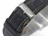 a close up of a watch with a leather strap