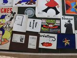 many different stickers on the wall of a building