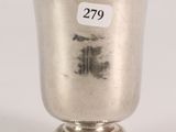 an antique silver cup with a number on the side of it