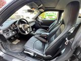 the interior of a black car with black leather seats and a steering wheel