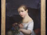 portrait of a young girl with a bouquet of flowers in a gold frame