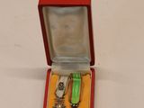 a small red box with a bunch of items inside of it