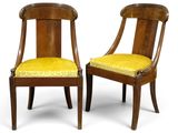 a pair of chairs with a yellow upholstered seat