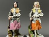 pair of figurines of a knight and a lady in armor