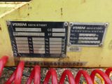 a close up of a red coil on a yellow machine