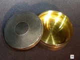 a small metal box with a lid on a table