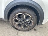 the tire of a car with a flat tire on a street